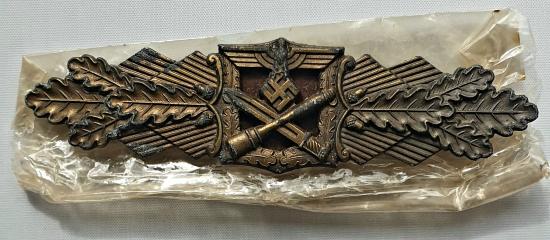 Bronze Close Combat Clasp with its original cellophane wrap.