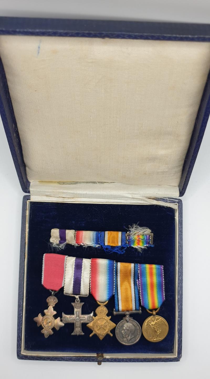 Cased WWI MBE, MC Gallantry 5 place miniature mounted group with ribbon bar.