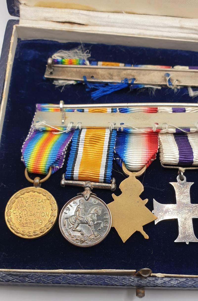 Cased WWI MBE, MC Gallantry 5 place miniature mounted group with ribbon bar.